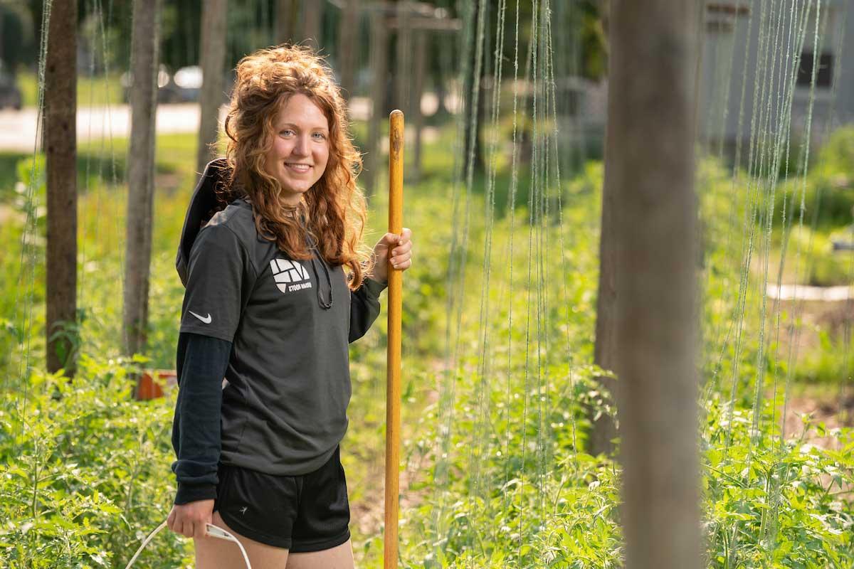 student with shovel in garden